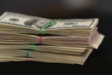 Close up on stacked bundles of 100 USD bills