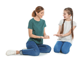 Fototapeta premium Hearing impaired mother and her child talking with help of sign language on white background