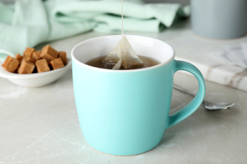 Cup of delicious hot tea on table