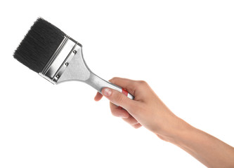 Woman holding paint brush on white background, closeup