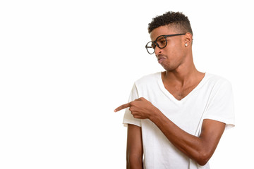 Young handsome African man pointing finger looking upset