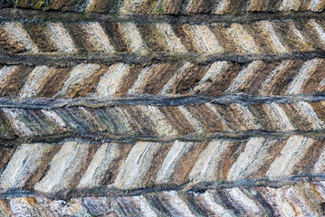 Peat structure of traditional Icelandic turf construction made of clamped blocks with strips between the layers.