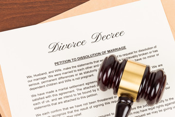 Wooden judge gavel and divorce decree; document is mock-up