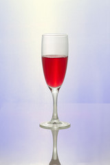 Glass with red wine on a blue background