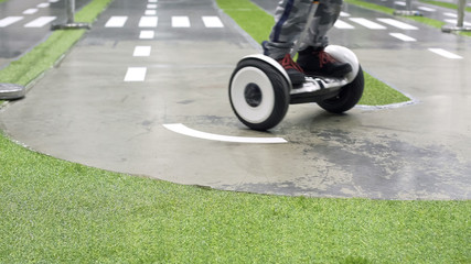 Boy driving personal transporter, active outdoors on two-wheeler, transportation