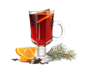 Glass cup of mulled wine with fir branch and orange isolated on white