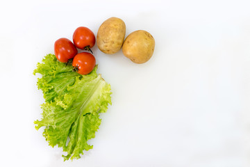 Tomato potato and lettuce isolated on white background with copy space. Healthy vegetables and herbs concept.