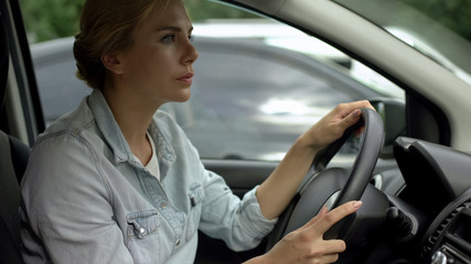 Unbelted woman driving car, risk of accident, traffic rules and regulations