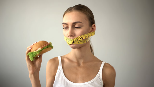 Anorexic girl ties mouth with tape, fights with temptation to eat burger