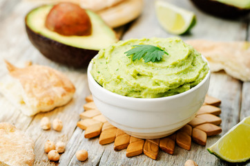 avocado hummus with pita and fresh avocado slices