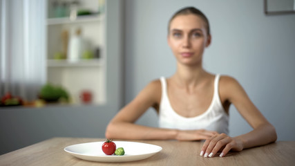 Obraz na płótnie Canvas Anorexic girl consciously choosing severe diet, mental disease, starving body