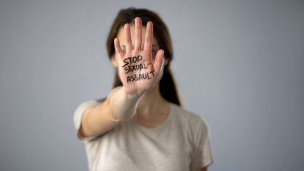 Stop sexual assault sign on womans hand, discrimination prevention, assault - 245212965