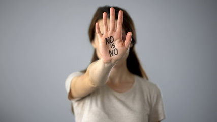 Female with no is no sign on hand, violence against women prevention, violence
