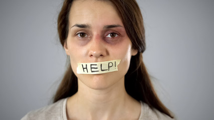 Help tape on womans mouth, silent request for help and protection, tyranny
