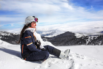 Fototapeta na wymiar Women sit in snow on mountain