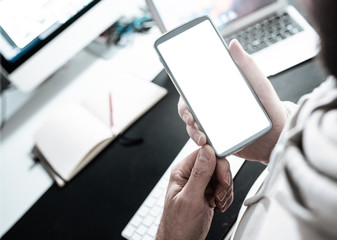 high angle view close-up of man using smartphone at office desk template