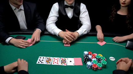 Upper class people playing poker game at elite casino, gambling entertainment
