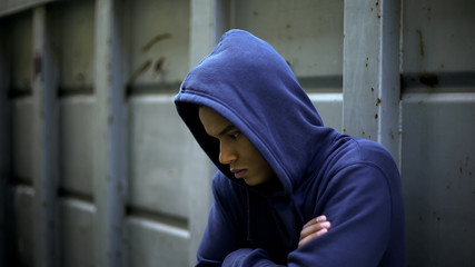 Antisocial teenager hiding from people, protesting against rules and injustice