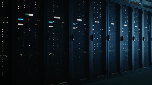 Moving Data Shot of Dark Data Center With Multiple Rows of Fully Operational Server Racks. Modern Telecommunications, Cloud Computing, Artificial Intelligence, Database, Supercomputer
