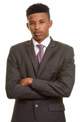 Young handsome African businessman with arms crossed