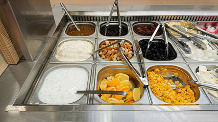 Concept of selling unhealthy food by weight in a store. Vegetables, fruits, meat, salad.