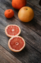 Fresh citrus fruits on color wooden background. Grapefruit, orange and mandarin