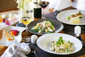 Various meals and desserts served at the restaurant table