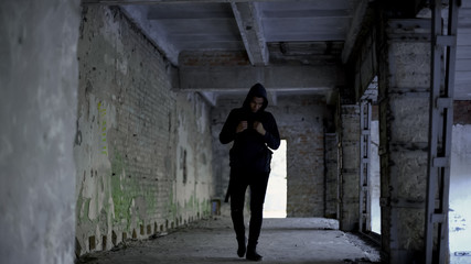 Fototapeta na wymiar Lonely boy walking in abandoned building, afro-american has no friends, racism