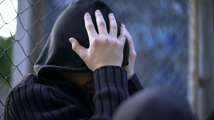 Teenage boy crying, school bullying, dysfunctional family, loneliness depression