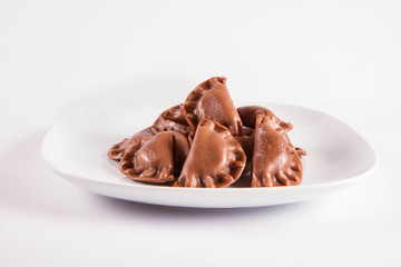 Traditional polish dumplings called pierogi - chocolate flavour with cheese