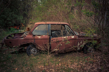 Destroyed and abanoded car in an abandoned place