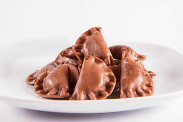 Traditional polish dumplings called pierogi - chocolate flavour with cheese