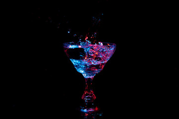 Glowing liquid splashing from champagne glass