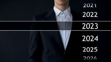 2023 year in virtual archive, businessman on background collection of statistics