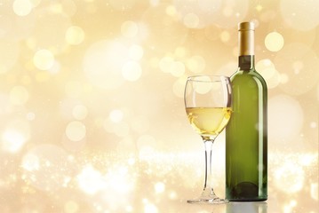 Glass and bottle of white wine on grunge background