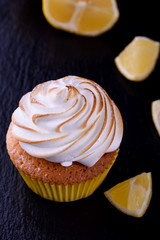 Lemon muffins with protein cream on a slate board with powdered sugar and honey