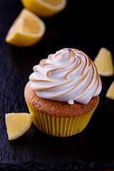 Lemon muffins with protein cream on a slate board with powdered sugar and honey