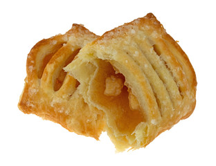 Broken pastry with apple filling isolated on a white background.