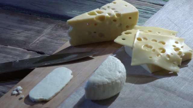 Several different cheeses on a wooden table