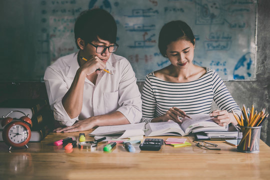High school or college Asian student group sitting at desk in class studying and reading, doing homework and lesson practice preparing exam to entrance, education concept