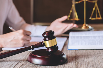 Male lawyer or judge working with Law books, gavel and balance, report the case on table in office,...