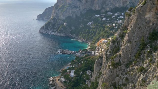 Mountains and the sea landscape of the Capri island, Italy. Located in the Tyrrhenian Sea, Capri has been a place of resort for several thousand years. Tilt shot, UHD