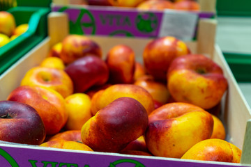 Peaches Packed boxes lying on the counter of the supermarket.