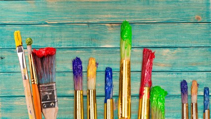 Row of artist paint brushes  on background
