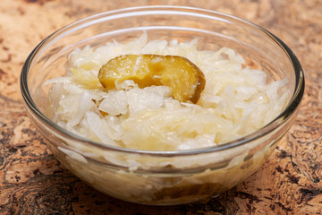 Traditional organic raw and fermented sauerkraut with pickled Persian cucumbers.
