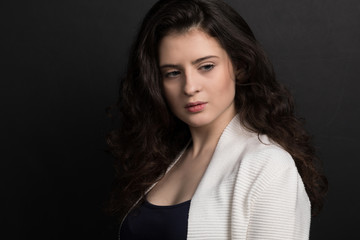 Obraz premium Portrait of beautiful young woman with voluminous curly hair 