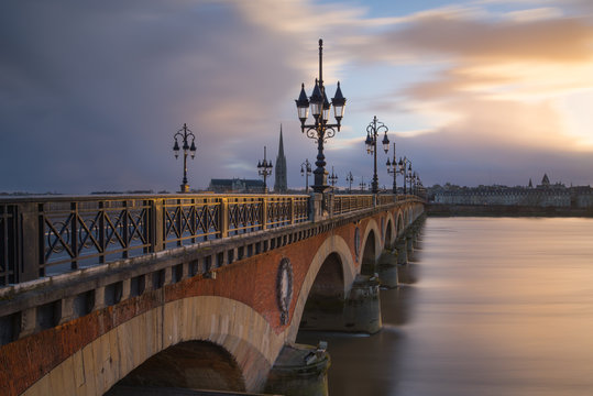 View of Pont de pierre bridge against cloudy sky