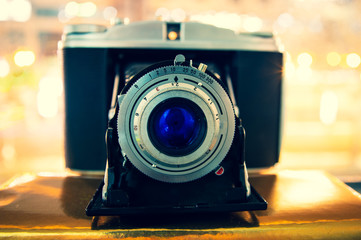 Old retro camera with blue lens and bellows