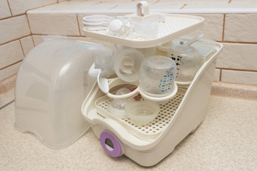 Close-up of baby bottle sterilizer. Used to disinfect bottles, manual breast pump, bottle nipples, teethers, pacifiers toys and other baby feeding items. Using the power of steam to kill the harmful h