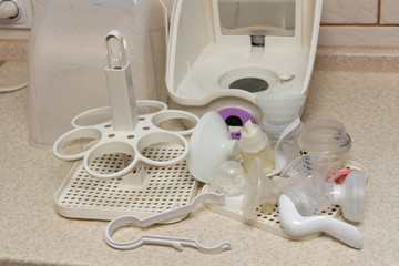 Fototapeta na wymiar Close-up of baby bottle sterilizer. Used to disinfect bottles, manual breast pump, bottle nipples, teethers, pacifiers toys and other baby feeding items. Using the power of steam to kill the harmful h